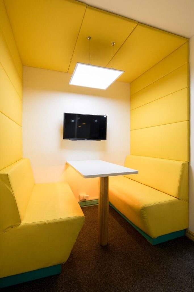 rectangular white wooden table near yellow padded couch