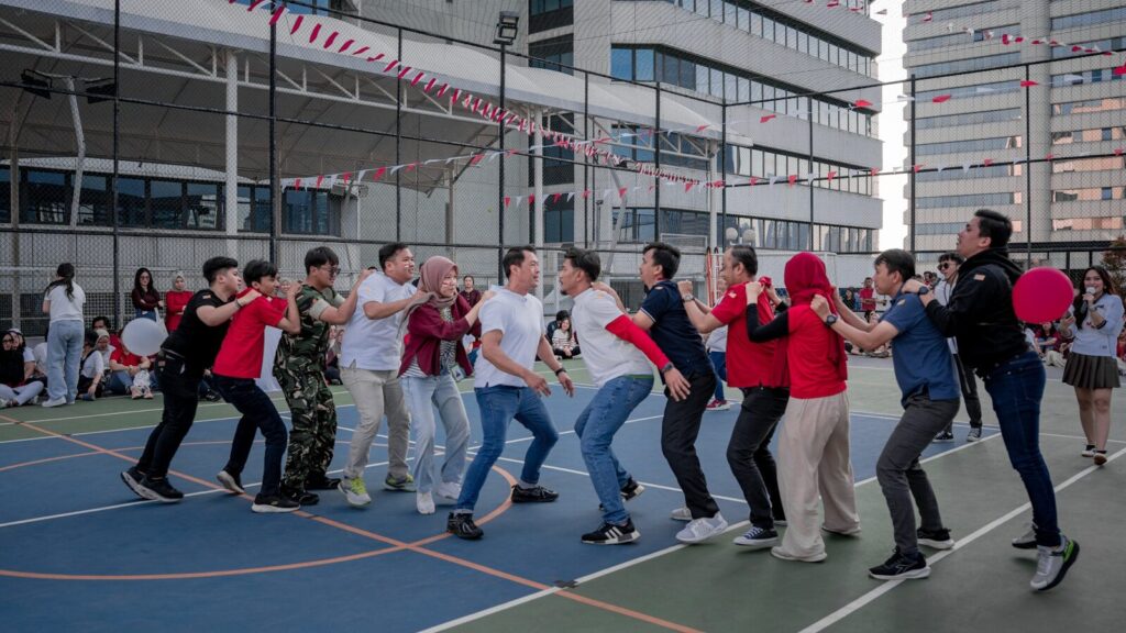 A group of people playing a tug-of-war game outdoors